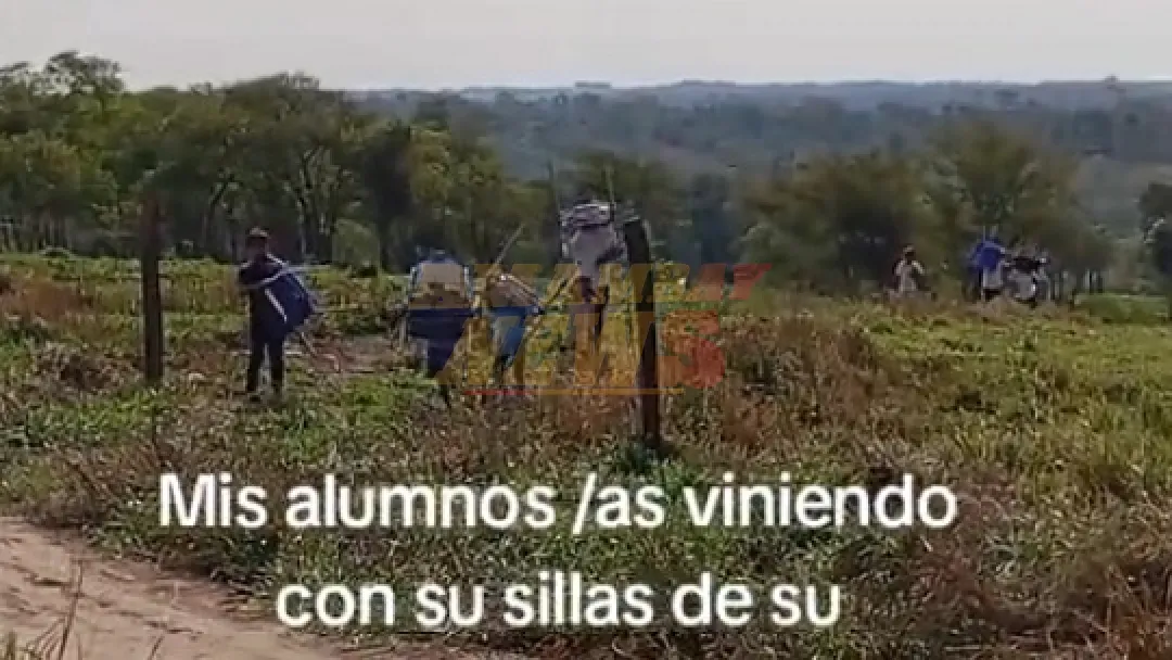 En Caaguazú, niños cargan sillas para estudiar en una precaria escuelita con techo de zinc